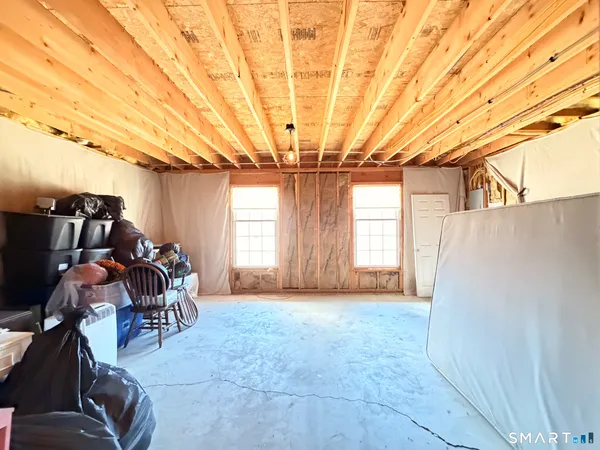 a aerial view of a house in front of a big yard with large trees