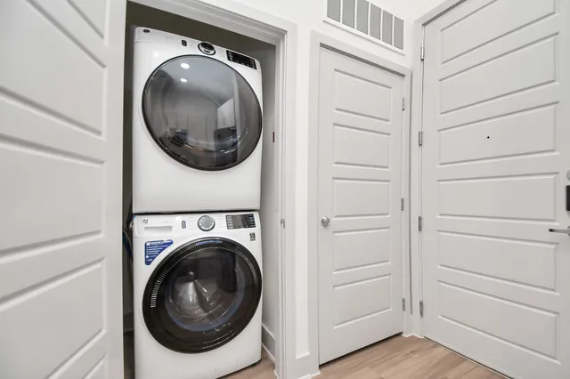 a view of a hallway and washer and dryer