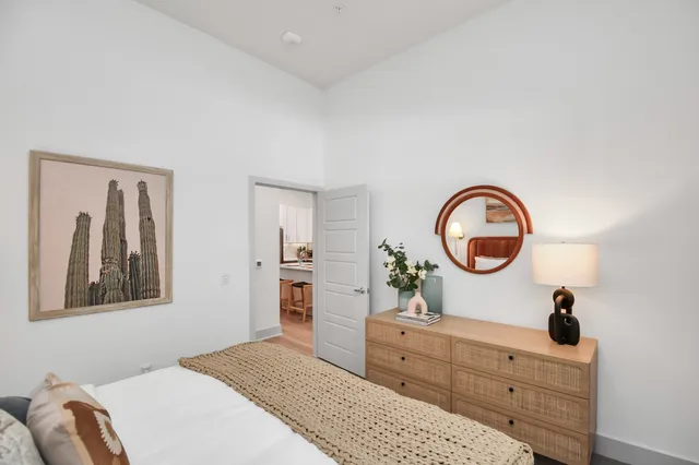 a bedroom with a bed and a dresser