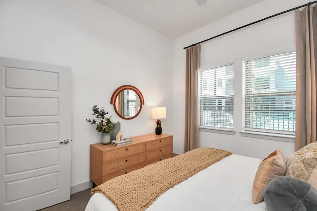 a bedroom with a bed and a large window