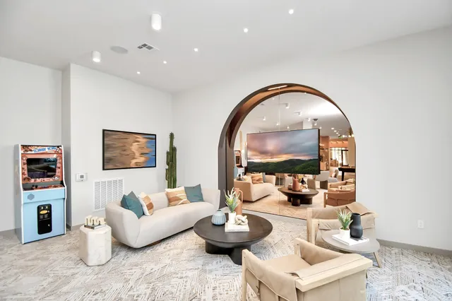 a living room with furniture and a wooden floor