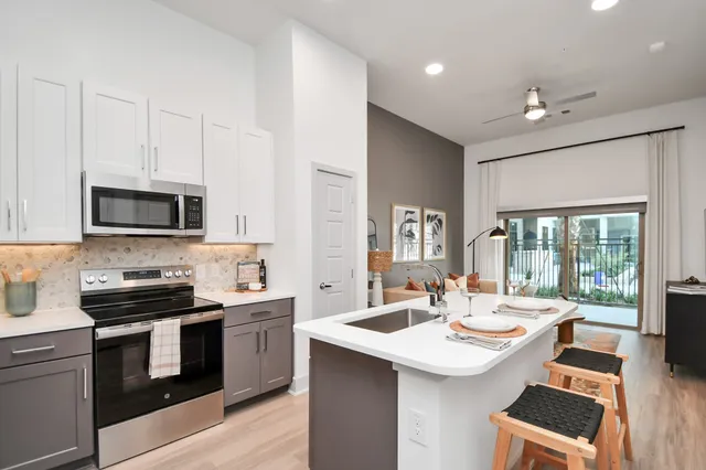 a kitchen with a sink stove and microwave