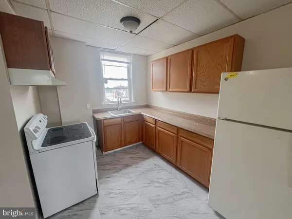 a kitchen with a refrigerator sink and stove
