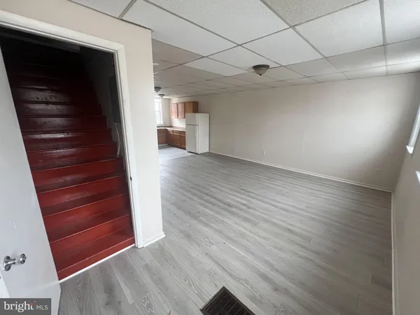 a view of a hallway with wooden floor and stairs