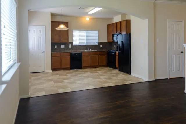 a kitchen with granite countertop a refrigerator and a stove