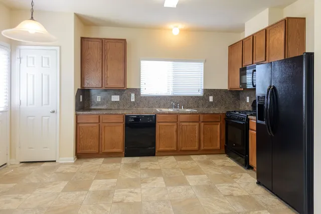 a kitchen with a sink stove and refrigerator