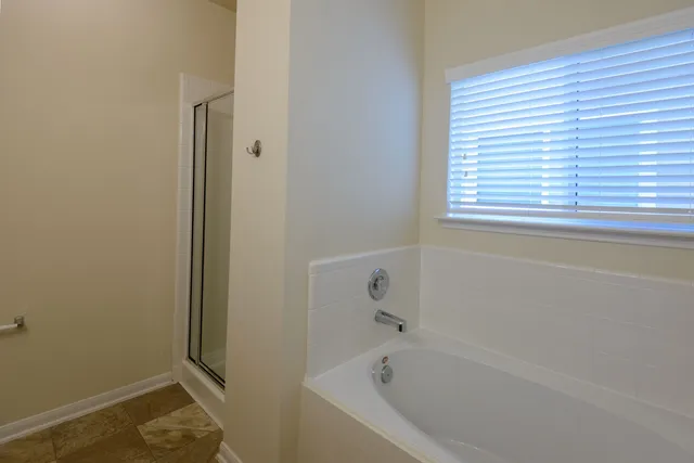a white bath tub sitting next to a window