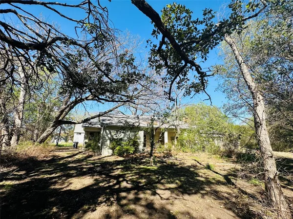 a view of a yard covered with snow in front of house