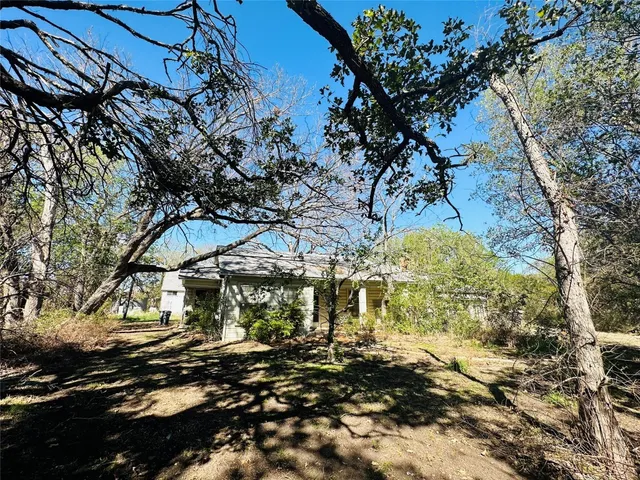 a view of a yard covered with snow in front of house