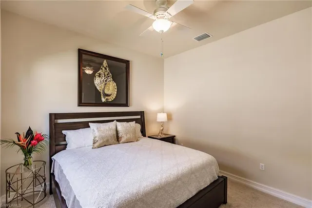 a bedroom with a bed and a painting on the wall