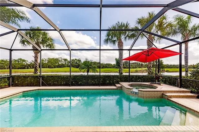 a view of swimming pool with patio and a yard
