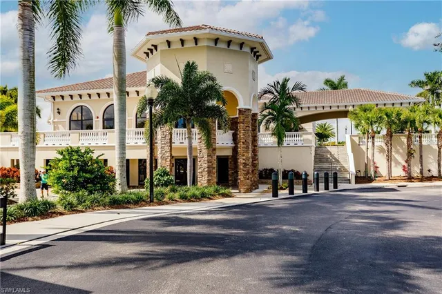 a front view of multi story residential apartment building with yard and sign board