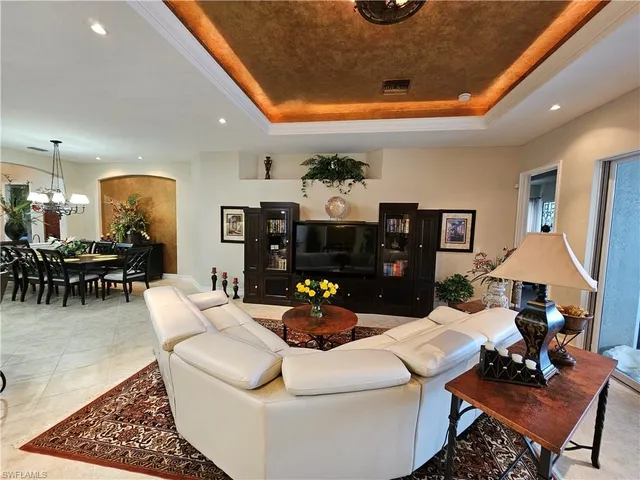 a living room with furniture and a chandelier