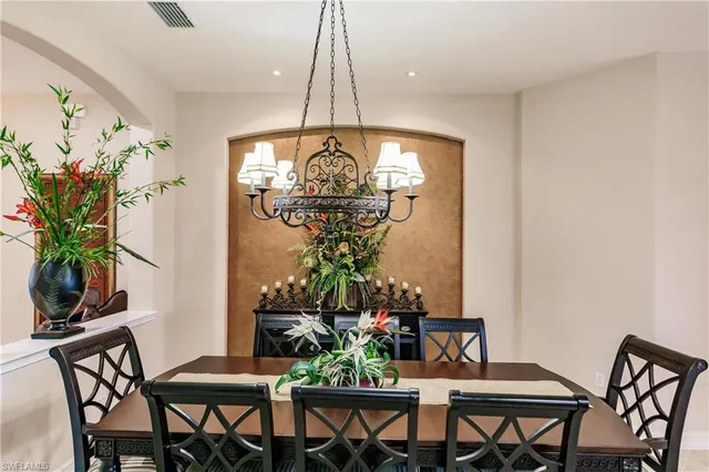 a view of a dining room with furniture and chandelier
