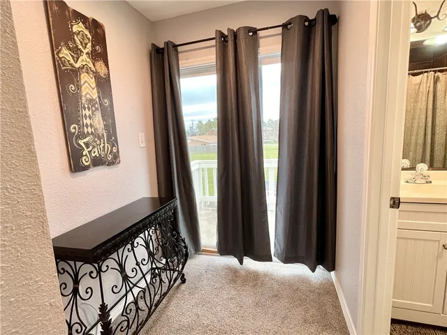 a view of a balcony with furniture and a window