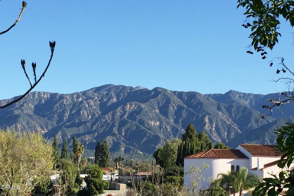 a view of a house with a mountain and a forest