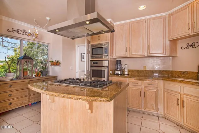 a kitchen with stainless steel appliances granite countertop a sink and cabinets