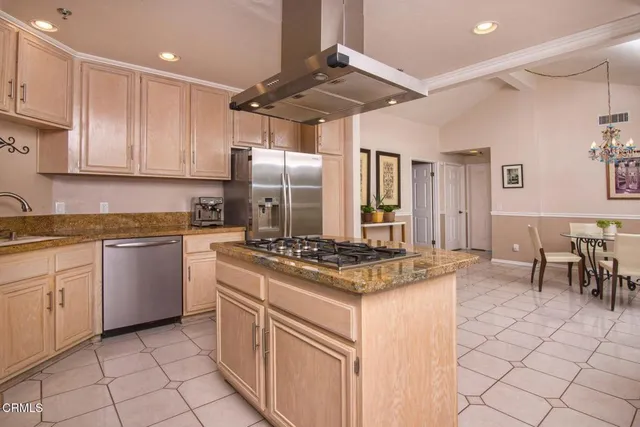 a kitchen with granite countertop a sink stove and cabinets