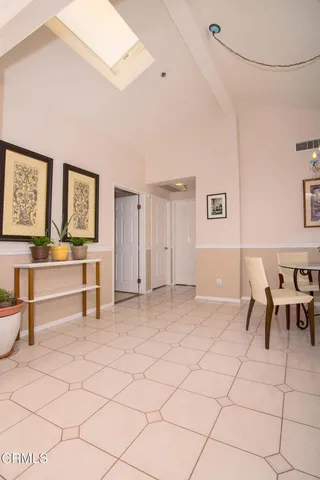 a view of a livingroom with furniture and a dining table