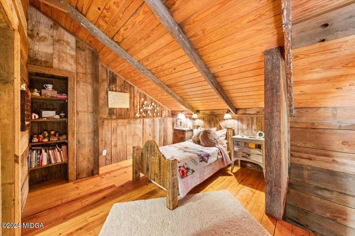 228 Pine Grove Church Road Culloden, GA 31016 - Photo 30 of 40 a spacious bedroom with a bed and wooden floor