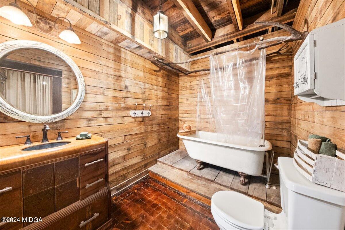 228 Pine Grove Church Road Culloden, GA 31016 - Photo 32 of 40 a bathroom with a sink a toilet and shower