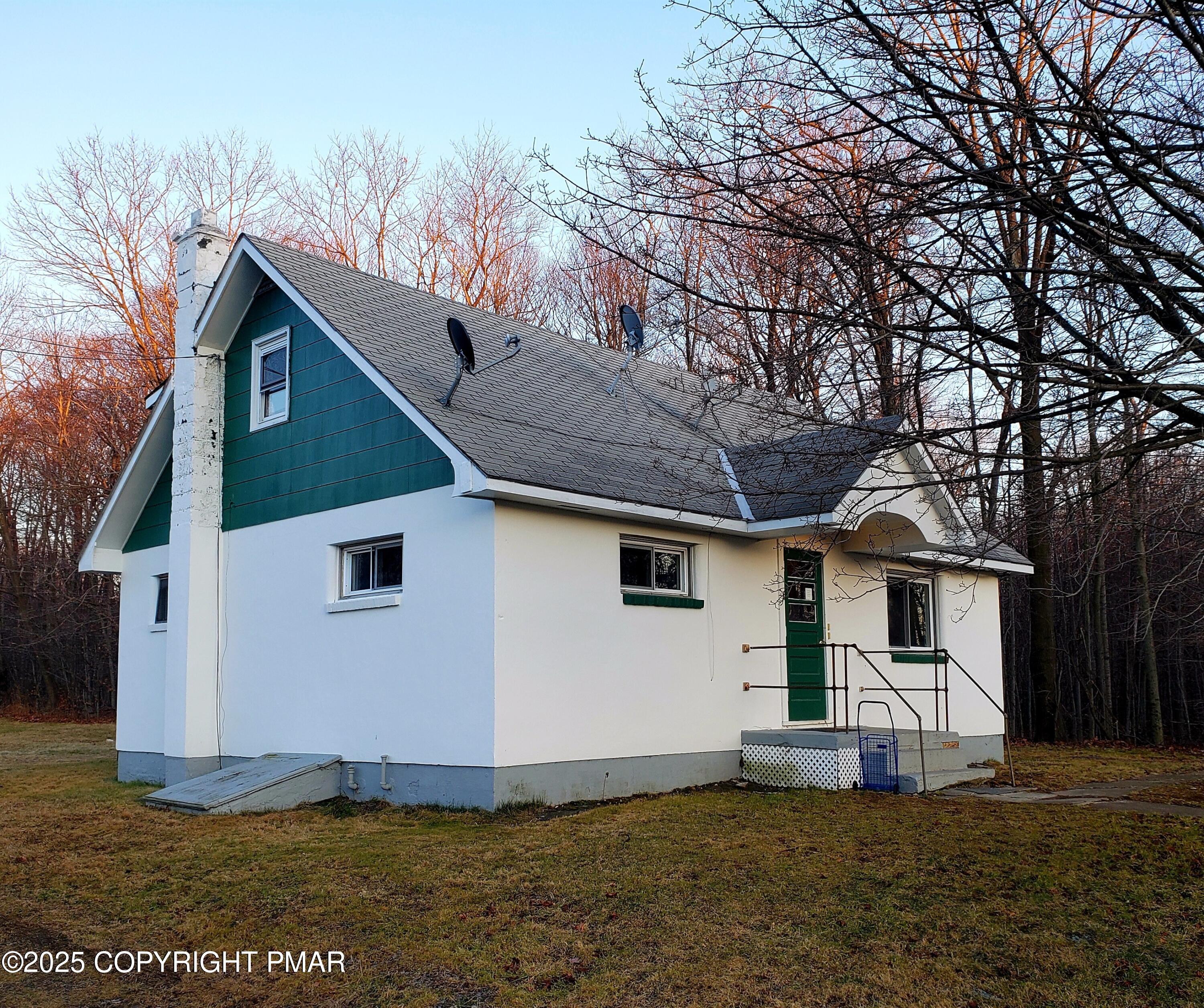 112 Crow Path, Unit 101 Tobyhanna, PA 18466 - Photo 1 of 8 a front view of a house with a yard