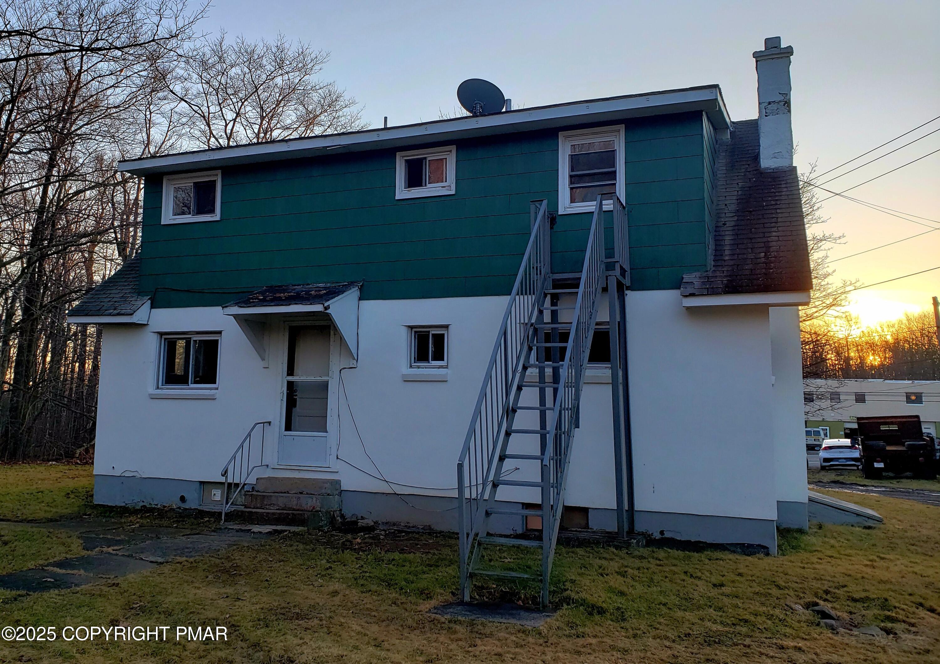 112 Crow Path, Unit 101 Tobyhanna, PA 18466 - Photo 2 of 8 a house that has a tree in front of the house