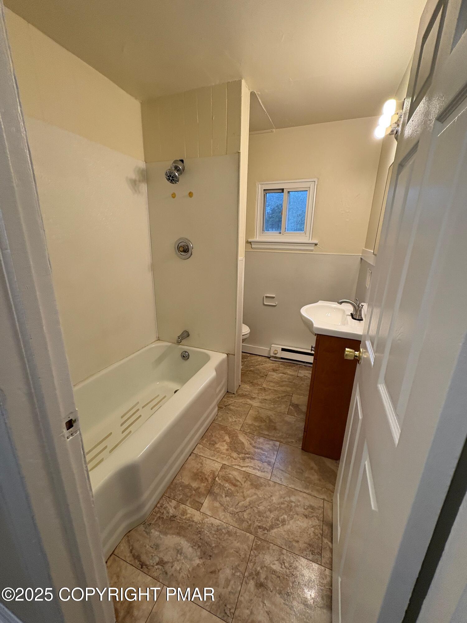 112 Crow Path, Unit 101 Tobyhanna, PA 18466 - Photo 6 of 8 a bathroom with a tub a sink a toilet and a shower