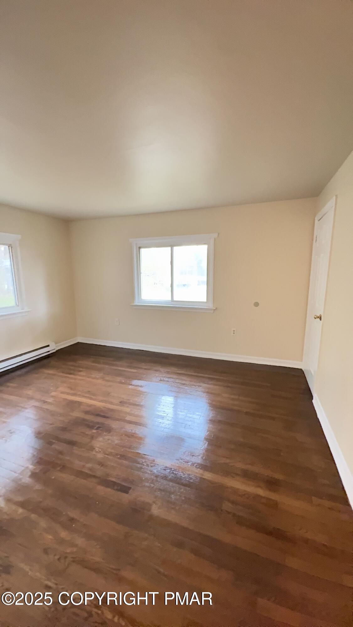 112 Crow Path, Unit 101 Tobyhanna, PA 18466 - Photo 8 of 8 an empty room with wooden floor and windows