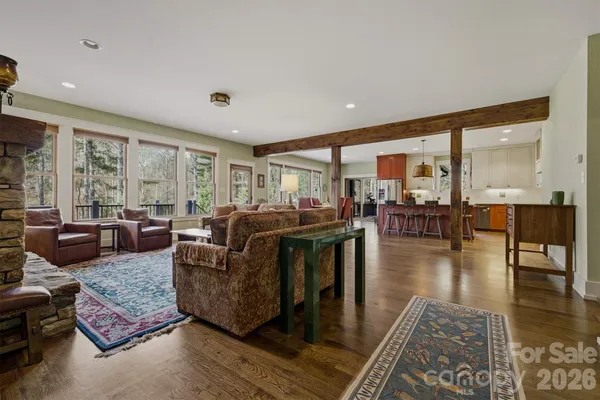 a living room with stainless steel appliances kitchen island granite countertop furniture and a dining table
