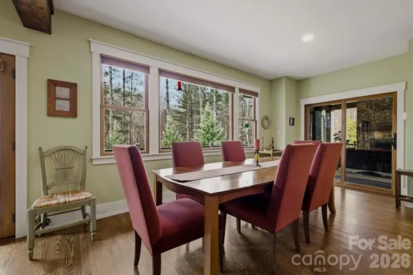 a kitchen with a table a refrigerator and cabinets