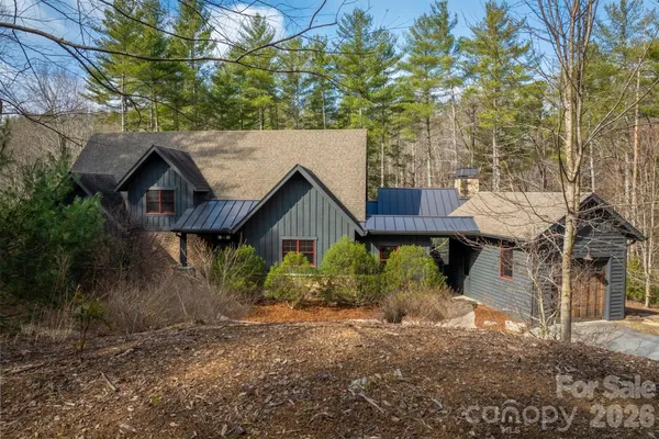 a view of a barn in the middle of a yard