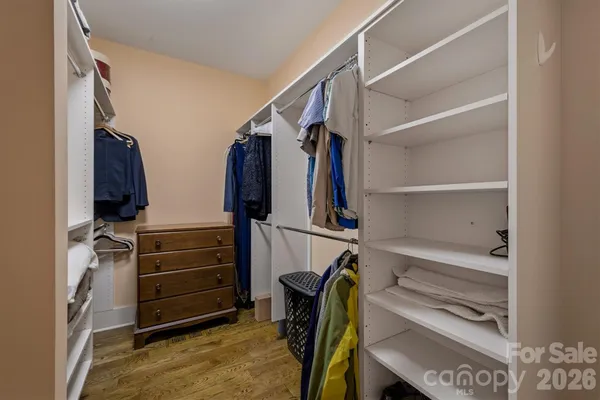 a en suite bathroom with a granite countertop sink and a mirror
