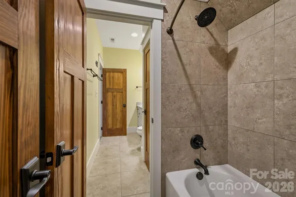 a bathroom with a granite countertop toilet sink and mirror