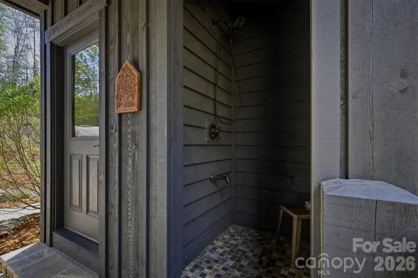 a wooden bench sitting in the middle of a yard