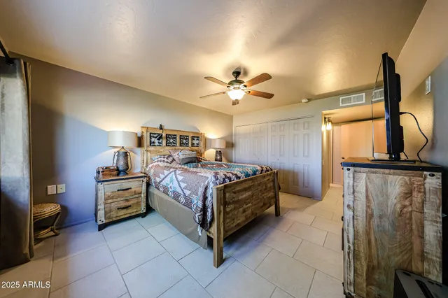 a bedroom with a bed and a chandelier