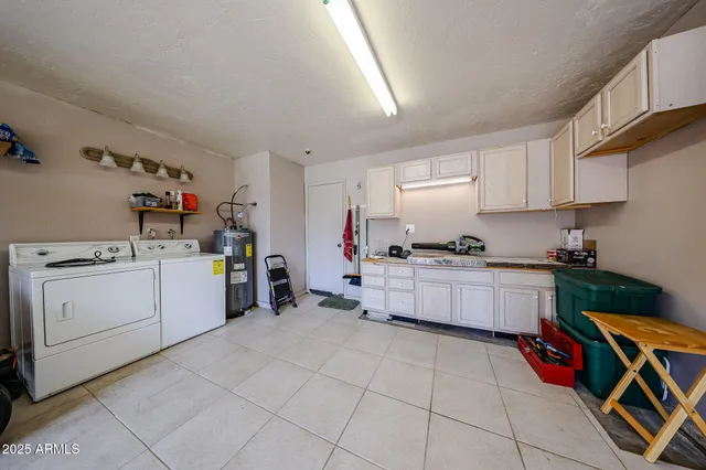 a kitchen with a white stove top oven and cabinets