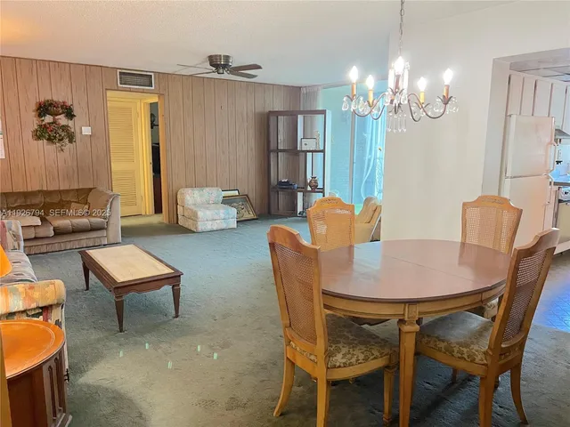 a dining room with furniture and chandelier