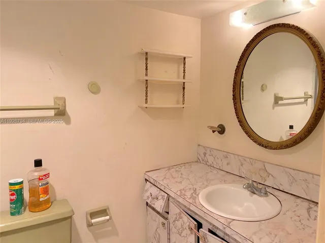 a bathroom with a sink a mirror and a toilet