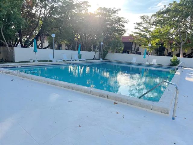 a view of swimming pool with a yard and sitting area