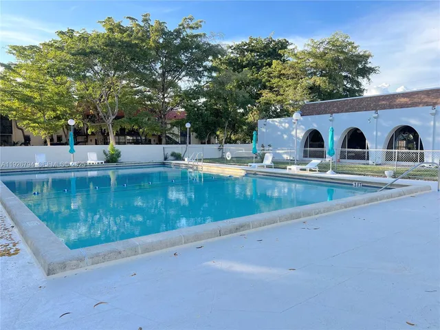 a view of pool with tree s