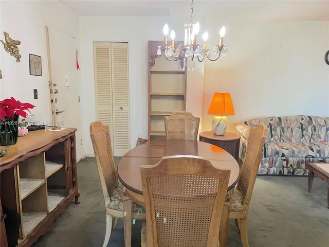 a view of a dining room with furniture and chandelier