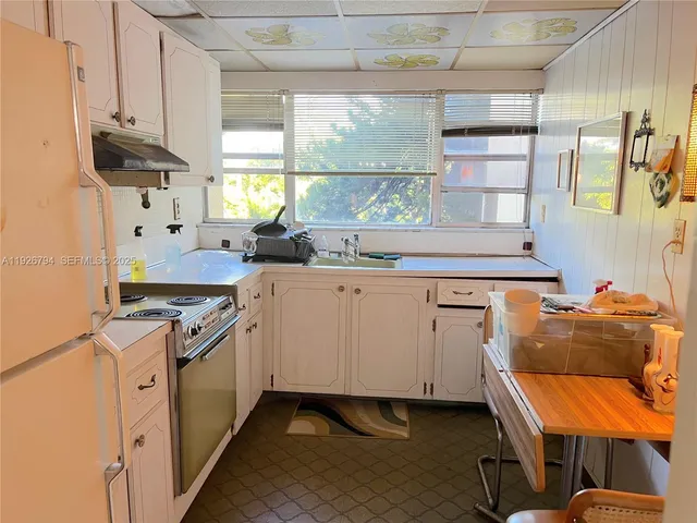 a kitchen with cabinets and window