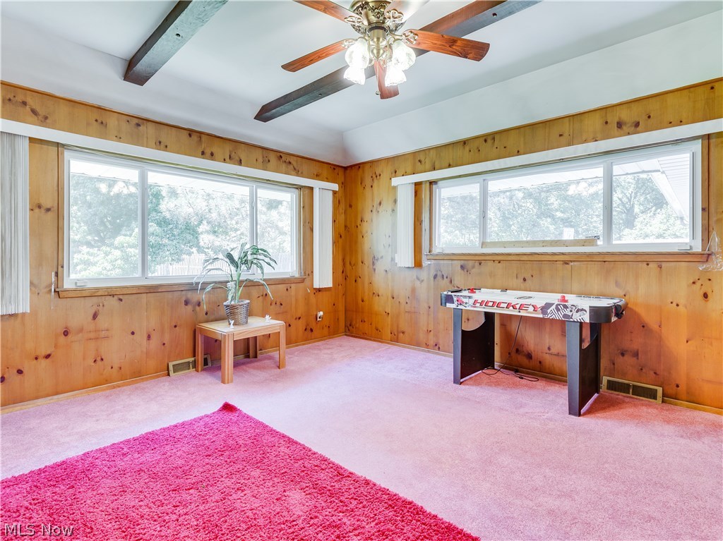 488 Harris Road Cleveland, OH 44143 - Photo 6 of 27 Family room off the dining room. Beamed ceiling, Knotty wood paneling, large windows and ceiling fan.