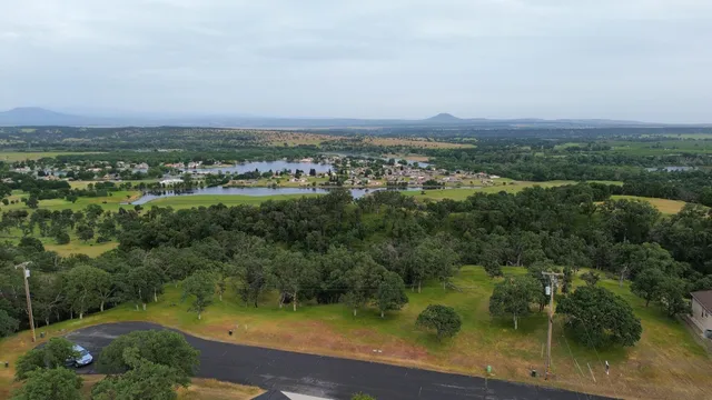 an aerial view of a houses with yard