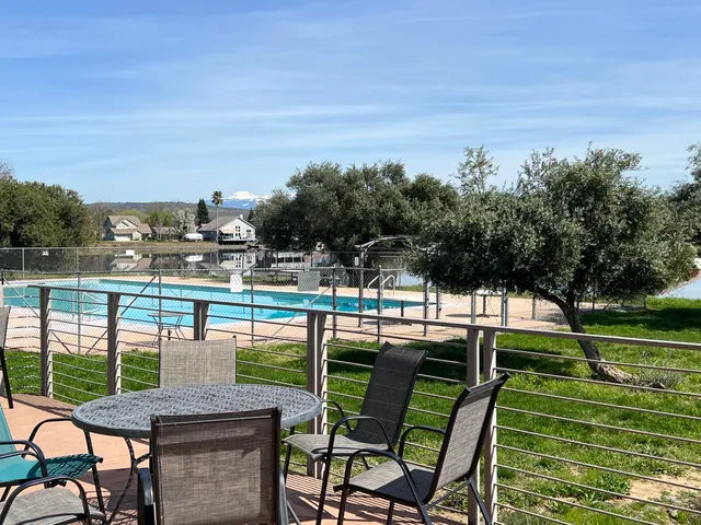 a large dining hall with stainless steel appliances granite countertop a sink and cabinets