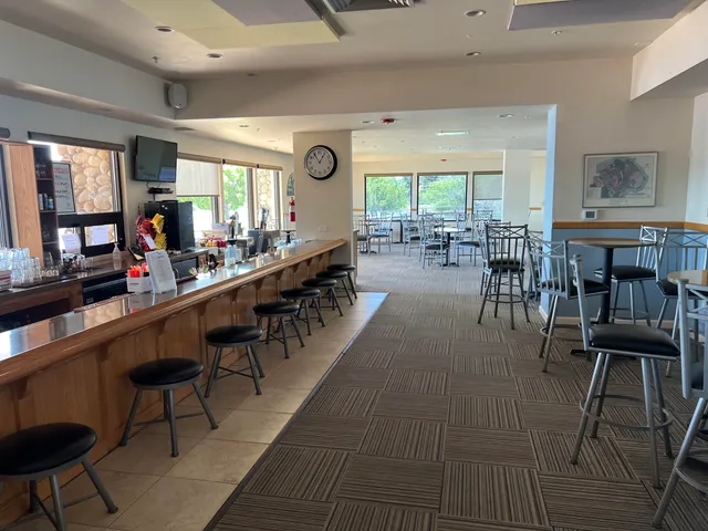 a room with pool table and windows