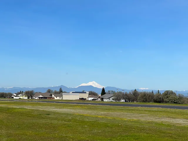 a view of a back yard of the house with a yard