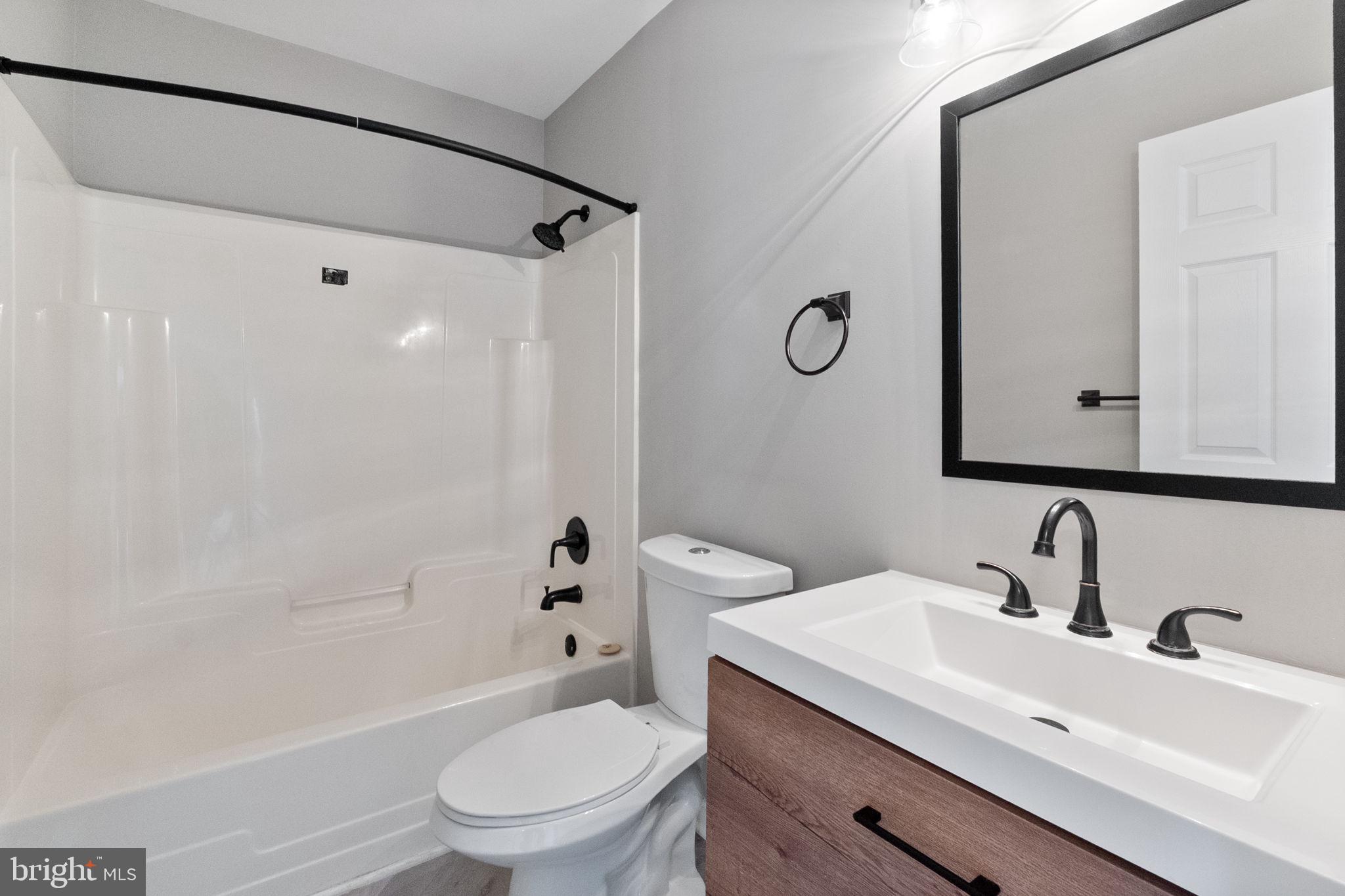 1527 Lincoln Road Shady Side, MD 20764 - Photo 13 of 30 a bathroom with a sink toilet a shower and a mirror