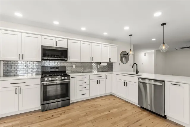 a kitchen with a sink stove and microwave